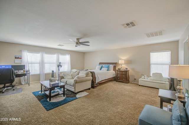 bedroom featuring carpet floors, visible vents, and multiple windows