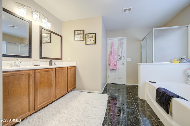 bathroom with granite finish floor, baseboards, visible vents, a sink, and a shower stall