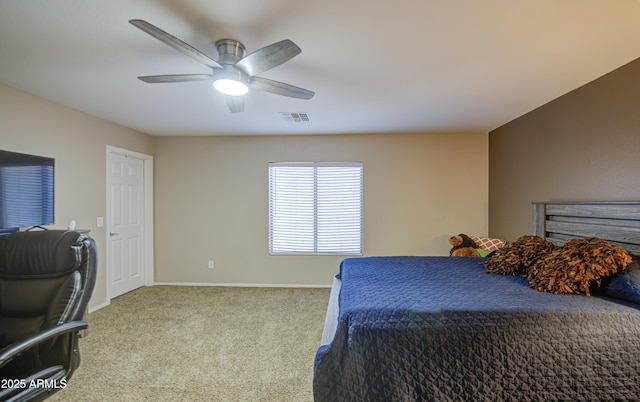 carpeted bedroom with visible vents, baseboards, and a ceiling fan