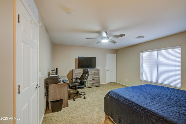 carpeted bedroom featuring baseboards, visible vents, and a ceiling fan