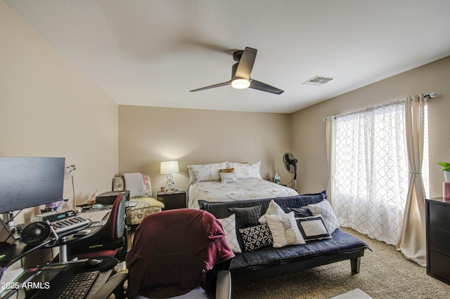 bedroom with light carpet, visible vents, and ceiling fan