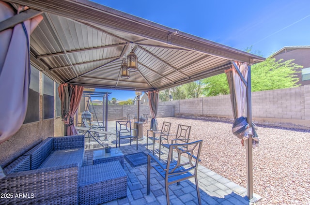 view of patio featuring an outdoor hangout area, a gazebo, and a fenced backyard