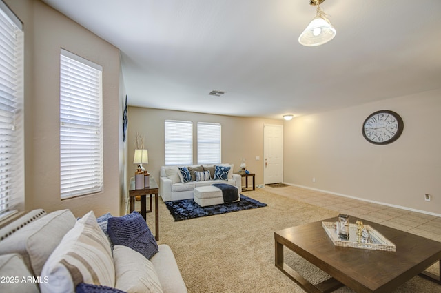 carpeted living room with visible vents and baseboards