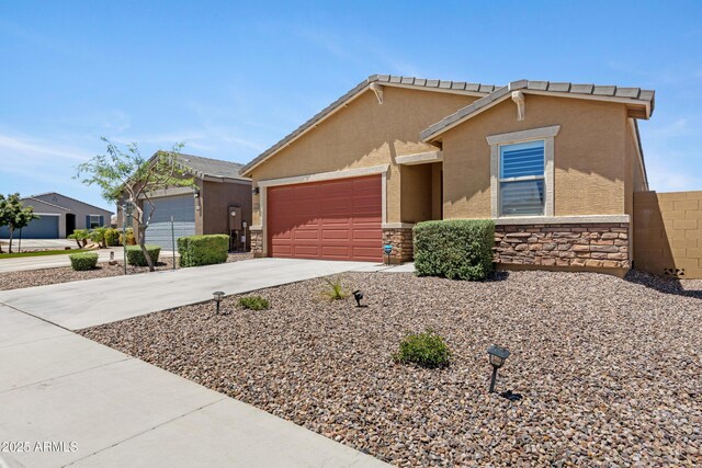 4628 W Greenleaf Dr, San Tan Valley, AZ 85144 - view of front facade featuring stone siding, concrete driveway, an attached garage, and stucco siding