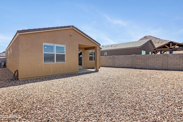 4628 W Greenleaf Dr, San Tan Valley, AZ 85144 - back of house featuring a fenced backyard, a patio area, and stucco siding