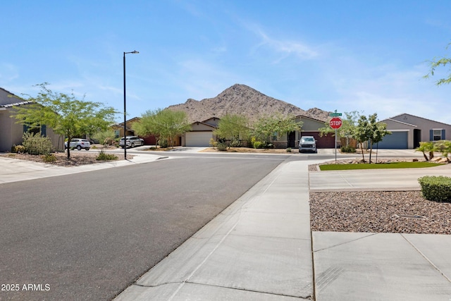 4628 W Greenleaf Dr, San Tan Valley, AZ 85144 - view of asphalt road with street lights, traffic signs, sidewalks, and a mountain view