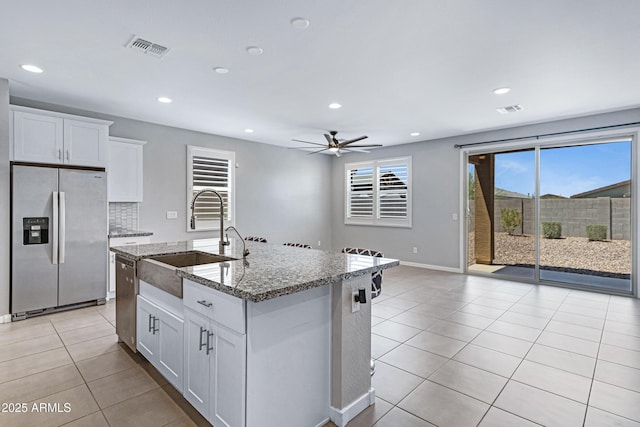 4628 W Greenleaf Dr, San Tan Valley, AZ 85144 - kitchen featuring appliances with stainless steel finishes, a sink, light tile patterned floors, ceiling fan, and light stone countertops