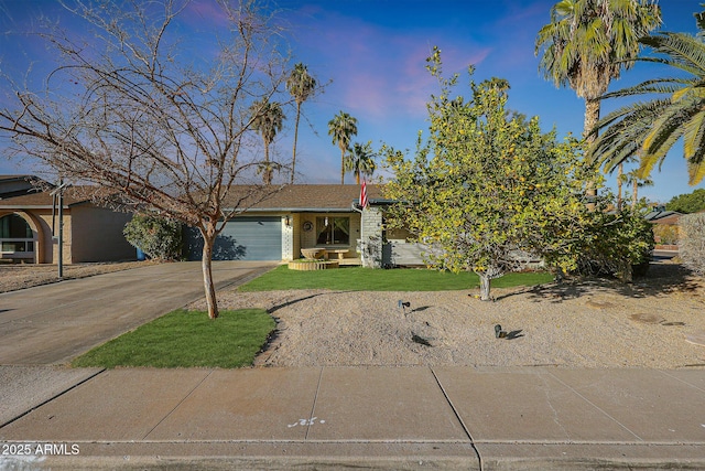 view of front of home featuring a garage and a lawn