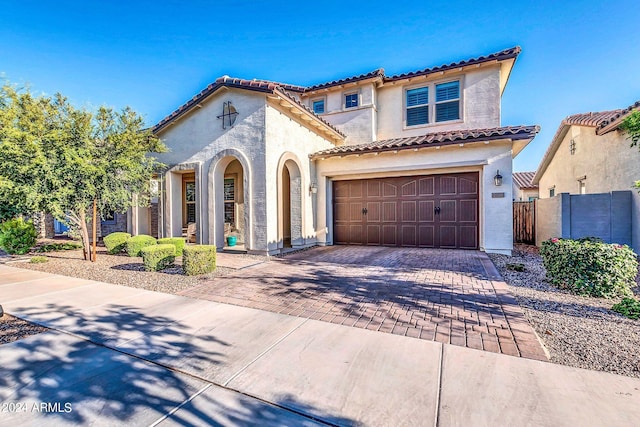 mediterranean / spanish house with a garage