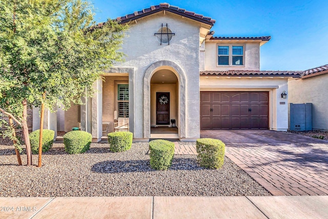 mediterranean / spanish-style home featuring a garage