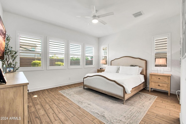 bedroom with light hardwood / wood-style floors and ceiling fan