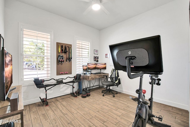 exercise room with light hardwood / wood-style floors and ceiling fan