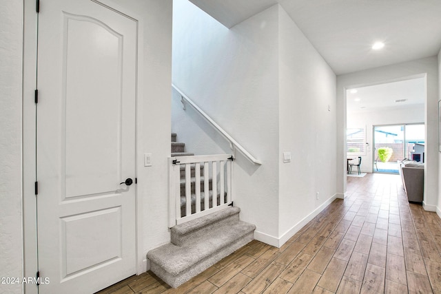 stairs featuring hardwood / wood-style flooring