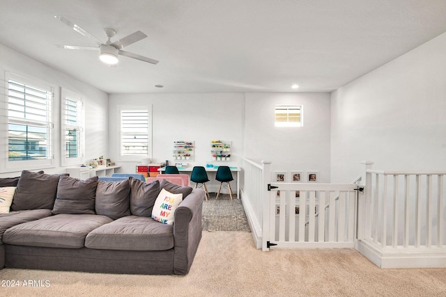 living room featuring ceiling fan and light colored carpet