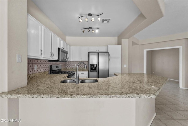 21192 E Stirrup St, Queen Creek, AZ 85142 - kitchen with visible vents, stainless steel appliances, light stone countertops, and a peninsula