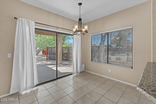 21192 E Stirrup St, Queen Creek, AZ 85142 - unfurnished dining area with light tile patterned floors, a wealth of natural light, a chandelier, and baseboards