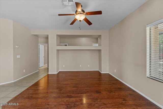 21192 E Stirrup St, Queen Creek, AZ 85142 - unfurnished living room featuring wood finished floors, visible vents, ceiling fan, and baseboards