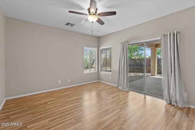 21192 E Stirrup St, Queen Creek, AZ 85142 - empty room featuring a ceiling fan, visible vents, wood finished floors, and baseboards