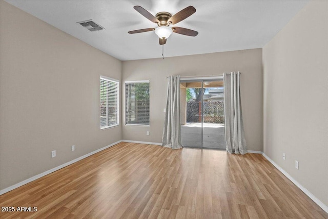 21192 E Stirrup St, Queen Creek, AZ 85142 - spare room featuring a healthy amount of sunlight, visible vents, wood finished floors, and a ceiling fan