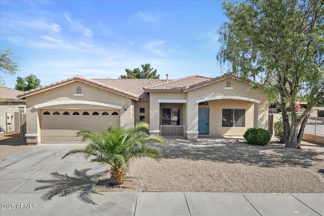 21192 E Stirrup St, Queen Creek, AZ 85142 - mediterranean / spanish-style house featuring fence, concrete driveway, a tiled roof, an attached garage, and stucco siding