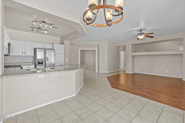 21192 E Stirrup St, Queen Creek, AZ 85142 - kitchen featuring light tile patterned flooring, white cabinetry, a peninsula, appliances with stainless steel finishes, and ceiling fan with notable chandelier