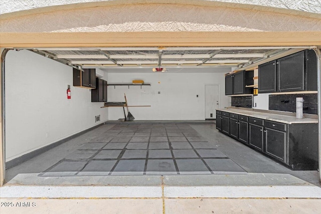 21192 E Stirrup St, Queen Creek, AZ 85142 - garage featuring a garage door opener and baseboards
