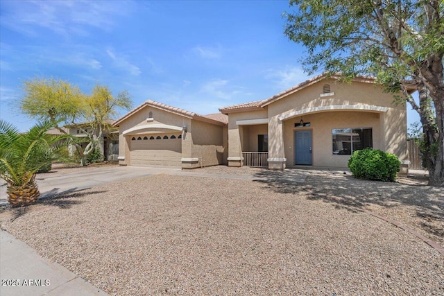 21192 E Stirrup St, Queen Creek, AZ 85142 - mediterranean / spanish-style home with a porch, stucco siding, a tiled roof, a garage, and concrete driveway