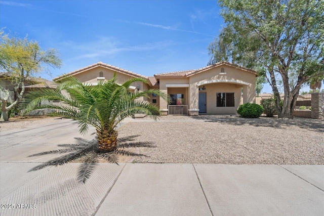 21192 E Stirrup St, Queen Creek, AZ 85142 - mediterranean / spanish house featuring fence, stucco siding, and a tile roof
