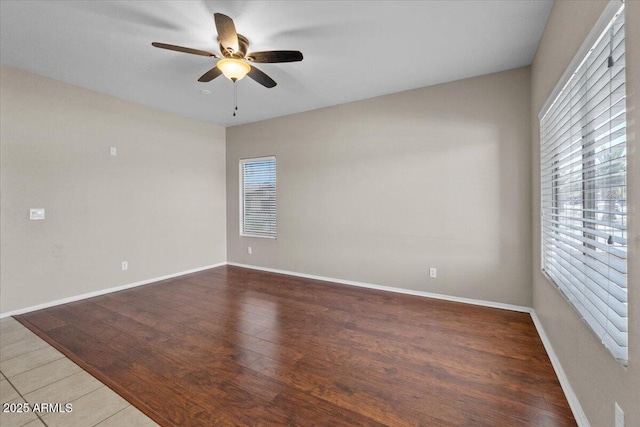 21192 E Stirrup St, Queen Creek, AZ 85142 - empty room featuring wood finished floors, a ceiling fan, and baseboards