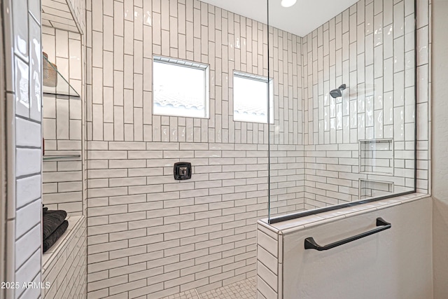 bathroom with tiled shower