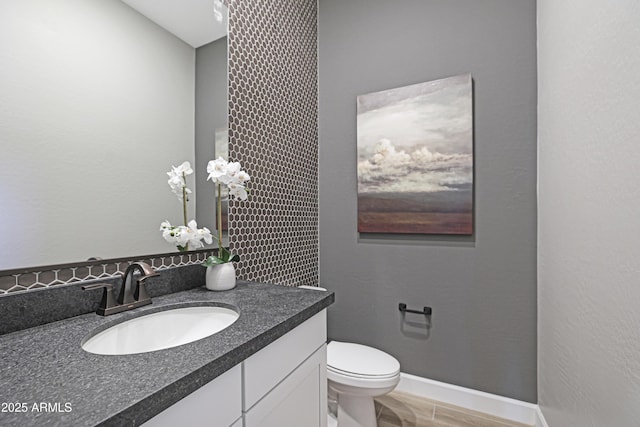 bathroom with vanity, hardwood / wood-style floors, and toilet