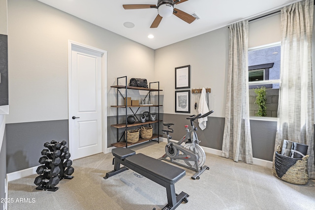 workout room with light colored carpet and ceiling fan