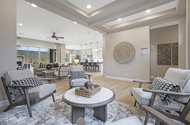 living room featuring light hardwood / wood-style flooring and ceiling fan