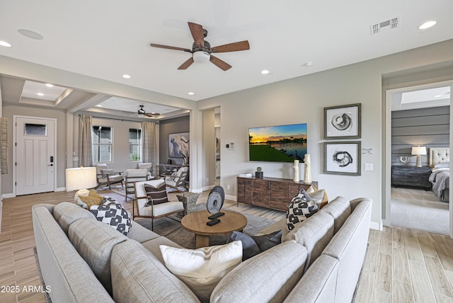 living room with ceiling fan and light wood-type flooring