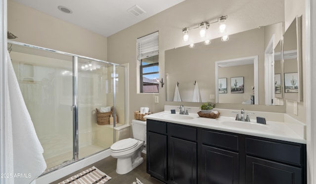 full bathroom featuring visible vents, a sink, a shower stall, and toilet