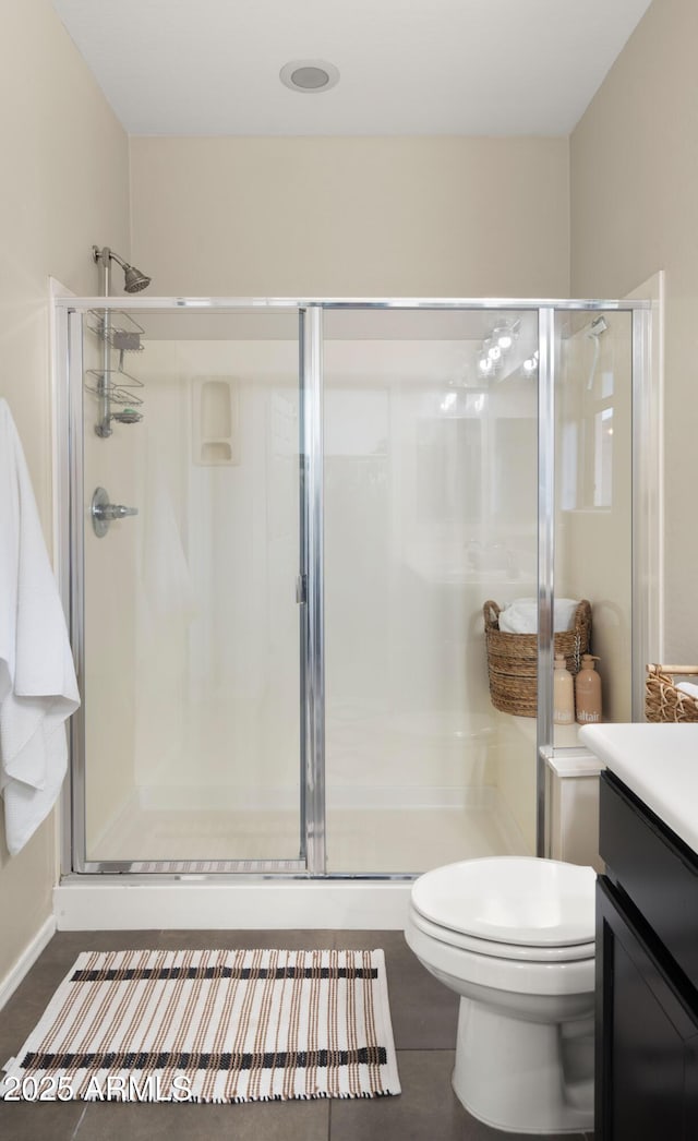 full bath featuring a stall shower, vanity, and toilet