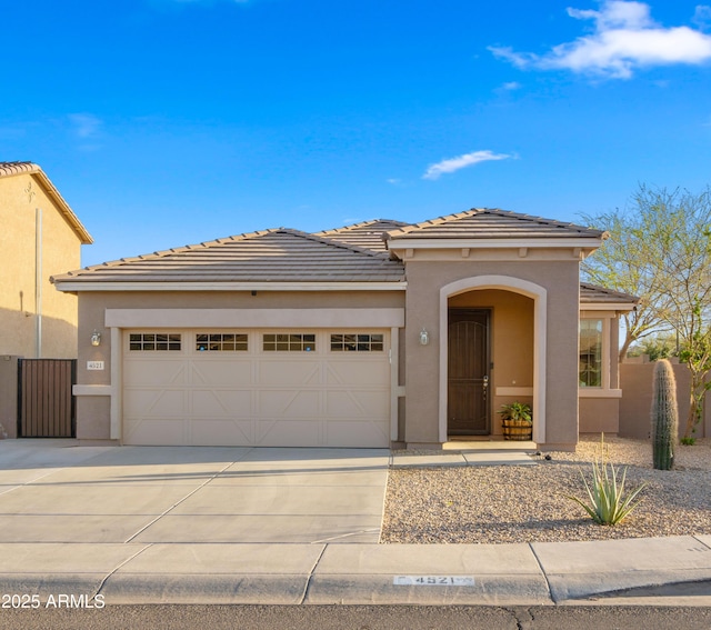 view of front facade featuring a garage, fence, concrete driveway, and stucco siding