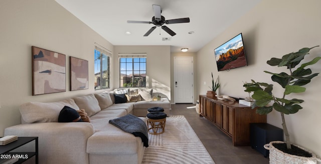 living area featuring dark tile patterned floors, recessed lighting, visible vents, and a ceiling fan