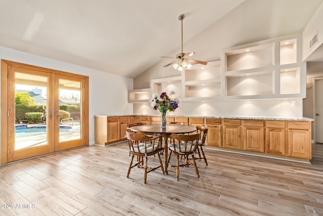 dining space with lofted ceiling, french doors, visible vents, and light wood-style flooring