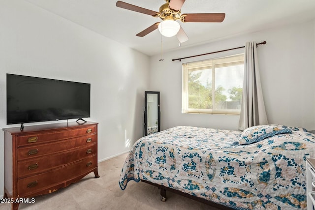 bedroom featuring light carpet and a ceiling fan