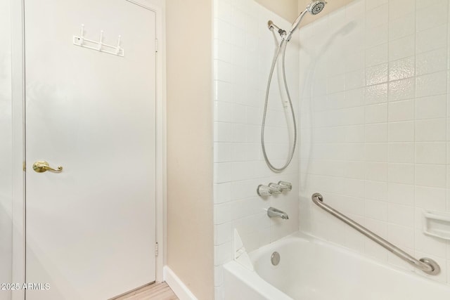 full bathroom with bathtub / shower combination and baseboards