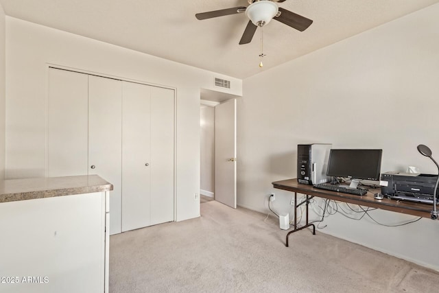 office area featuring light carpet, ceiling fan, and visible vents