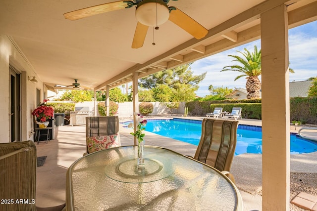 view of swimming pool featuring area for grilling, ceiling fan, a fenced backyard, outdoor dining area, and a patio area