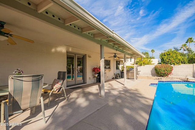 view of patio with ceiling fan, french doors, a fenced backyard, and a fenced in pool