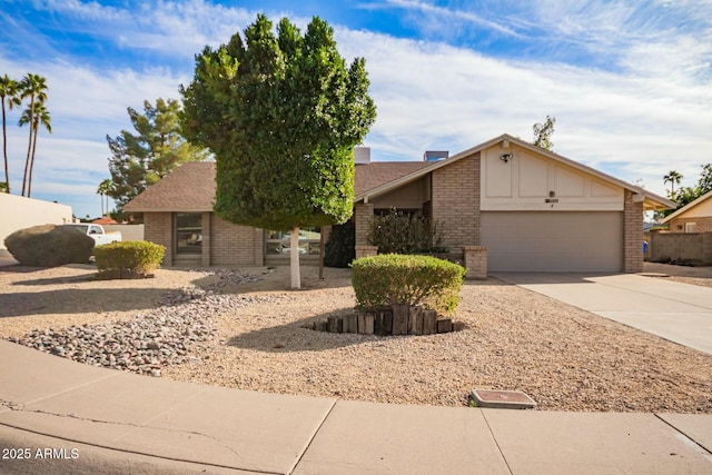 mid-century home featuring driveway, a garage, and brick siding