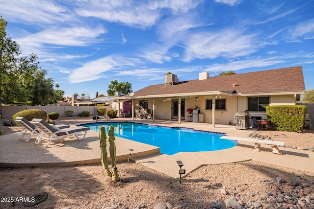 view of pool with a fenced in pool, a patio area, fence, and a diving board