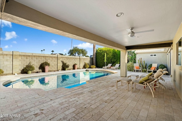 view of swimming pool with ceiling fan and a patio area