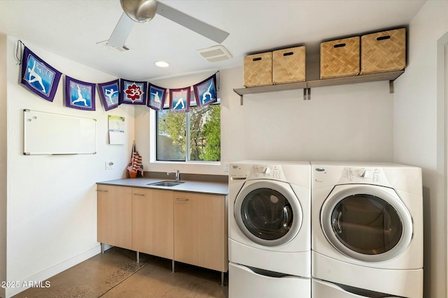 laundry area with cabinets, ceiling fan, independent washer and dryer, and sink