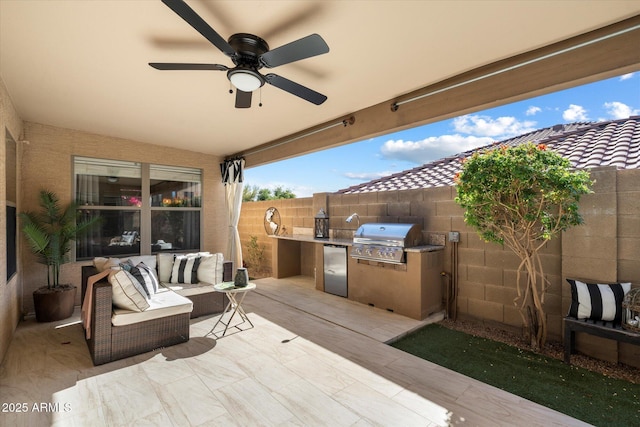 view of patio featuring ceiling fan, grilling area, and exterior kitchen