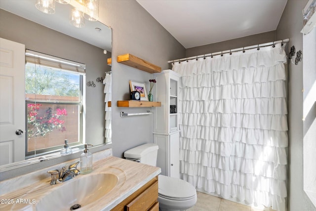 bathroom with vanity, toilet, curtained shower, and tile patterned flooring